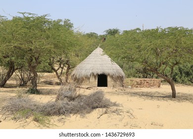 Tharparkar Sindh, Pakistan - March, 2019:  Village Huts In Thar Desert Old Poor Houses Animals In Rajhastan India, Hinduism In Pakistan Hindu Religion People