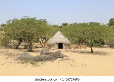 Tharparkar Sindh, Pakistan - March, 2019:  Village Huts In Thar Desert Old Poor Houses Animals In Rajhastan India, Hinduism In Pakistan Hindu Religion People