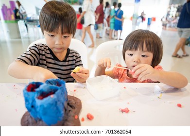 That cute happy little Asia boy and girl making stationary handmade from Paper and oven clay / two Asian kids playing clay in Learning center for children - Shutterstock ID 701362054