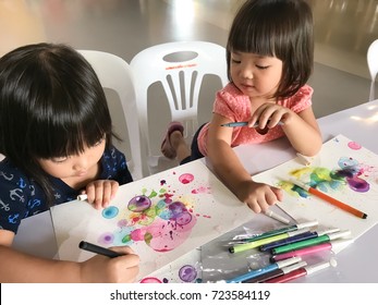 That Cute Happy Little Asia Boy And Girl Making Paper Art From Color Bubble With Soup / Two Asian Kids Drawing Art In Learning Center For Children