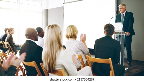 That deserves a round of applause. Cropped shot of a handsome mature businessman giving a speech during an award ceremony. - Powered by Shutterstock