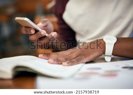 That time before the test when you revising. Closeup shot of an unrecognizable university student using a cellphone in class.