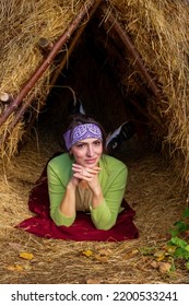 Thatched Hut In The Autumn Forest. Cabin In The Countryside. Happy Woman Is Resting In Nature. Escape From The Bustle Of The City To Nature.