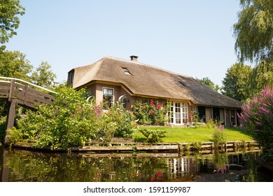 The thatched roof house with beatiful garden in fairytale village Giethoorn in The Netherlands.