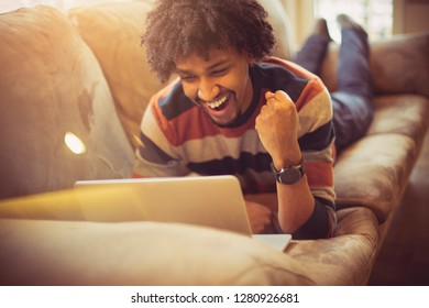 That's Right, The Effort Paid Off. African American Man Using Laptop At Home.