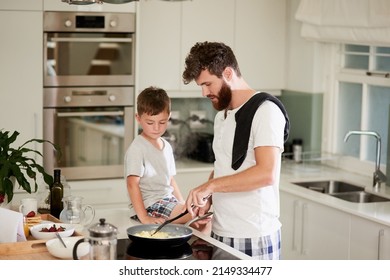 And thats the secret to fluffy scrambled eggs. Shot of an adorable little boy and his father making breakfast together at home. - Powered by Shutterstock