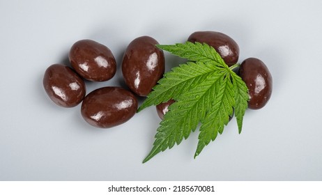 THC Chocolate Sweets,chocolate Candies And Marijuana Leaf On A Gray Background.