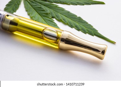 THC Oil Extract In Cartridge Up Close Up Cannabis Vaping Isolated on White With Marijuana Leaf