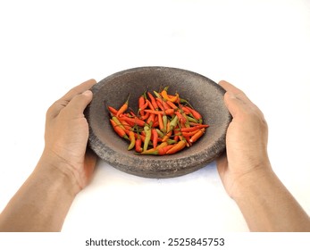 "The hand holding a mortar with red chili on top."

 - Powered by Shutterstock