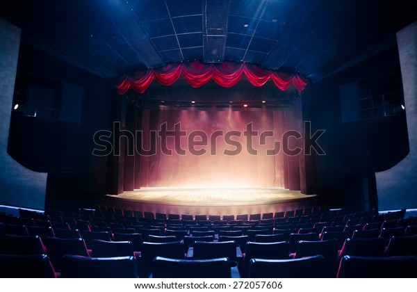 Theater curtain\
and stage with dramatic\
lighting