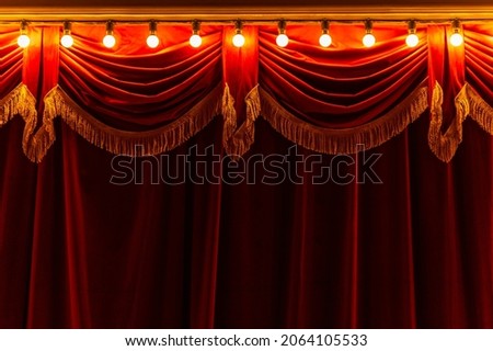 Theater red curtain and neon lamp around border	
