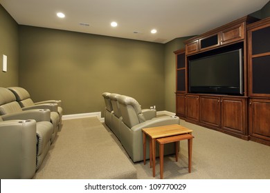 Theater room in luxury home with leather chairs