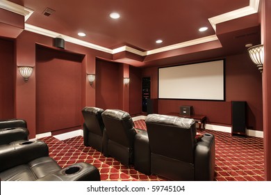 Theater room in luxury home with stadium seating