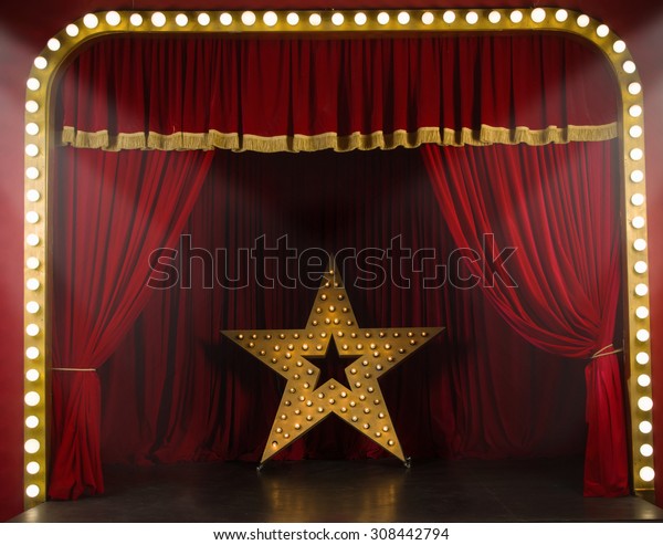 Theater stage with red curtains\
and spotlights. Theatrical scene in the light of searchlights\

