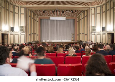 Theather Stage With People Silhouette At The Foreground.