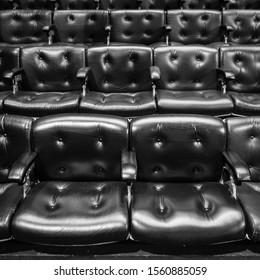 Theatre Seats. Full Frame Detail From Rows Of Raked Leather Seating In A Conference Or Concert Hall.