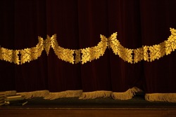 Theatrical Dark Red Velvet Curtain With Golden Fringe. Texture Background For Design.