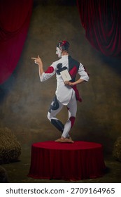 Theatrical jester turning back while holding hidden Joker card. Concept of gambling narratives, mystery elements, casino storytelling, and themed character art for campaign visuals.