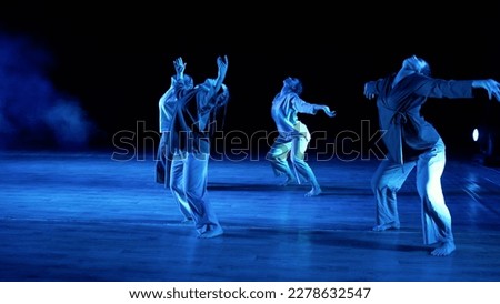Theatrical performance on stage. The girls on the stage are dancing a modern dance. Students rehearsing dance on stage. Girls dance modern dance on the stage.