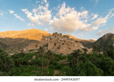 Thee Ain ancient village near Al-Bahah and Jeddah in Saudi Arabia with palm trees contrasting with desertic mountain in the Middle East - Powered by Shutterstock