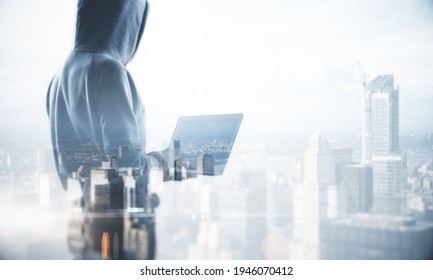 Theft Online Concept With Hacker Back Silhouette With Laptop And Foggy City Background. Mock Up, Double Exposure