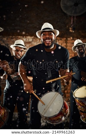 Their beats will keep you dancing all night long. Portrait of a group of musical performers playing drums together.