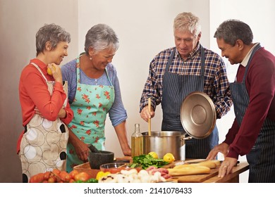 Their friendship is seasoned with love. Shot of a group of seniors cooking in the kitchen. - Powered by Shutterstock