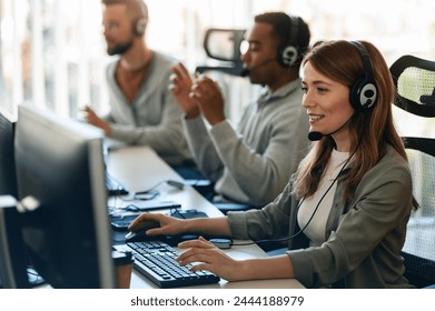 In their office, a multi-ethnic group of IT professionals works together, collaborating and using computers to accomplish their tasks - Powered by Shutterstock