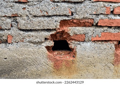 the theme of the building, red brick texture with large holes not covered with cement