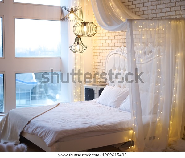 The theme is\
luxury and wealth. King size bed with cushioned and buttoned\
headboard in hotel room with classic baroque style interior. Close\
up, copy space, background.