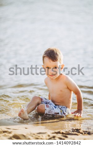 Similar – Cute little boy toaching the water with his feet.