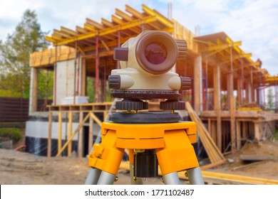 Theodelite Mounted On A Rack. Geodesy. Concept - Sale Of Theodelites. Level Is Fixed On The Tripod. Optical Level Near The House Under Construction. Optical Level. Concept - Equipment Of Gyodesist