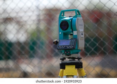 The Theodolite For Land Surveying On The Construction Site Of The Road Or Building With Construction Site Background.Theodolite Is A Precision Optical Instrument For Measuring Angles.
