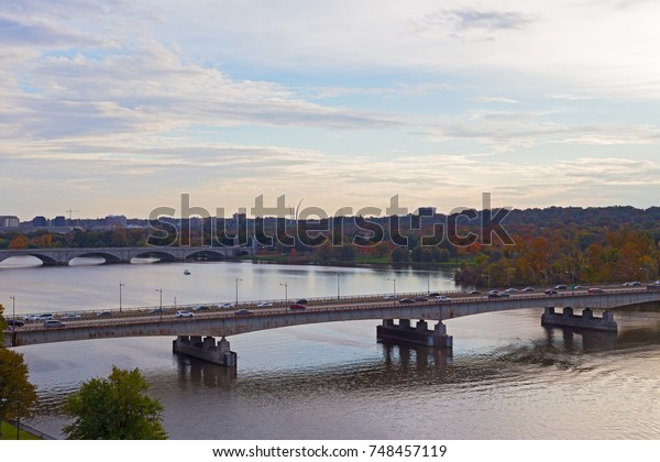 Theodore Roosevelt Bridge and Arlington Memorial\
Bridge at sunset in Washington DC, USA. Autumn US capital panorama\
along Potomac River.