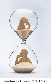 Theory Of Evolution Concept, With Falling Sand Taking The Shape Of A Monkey And A Man Inside A Hourglass