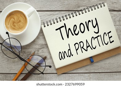 Theory and Practice Finance and business concept. On a wooden background with a cup of coffee and glasses
