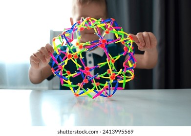 Therapeutic sensory activities for children's hands, neuropsychology, orthopedic correction. Child performs an exercise for tactile sensations on hand motor skills. Selective focus. - Powered by Shutterstock