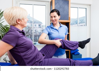 Therapist checking knee joint of senior woman