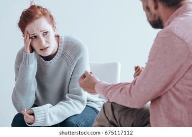 Therapist cheering up his extremely depressed patient