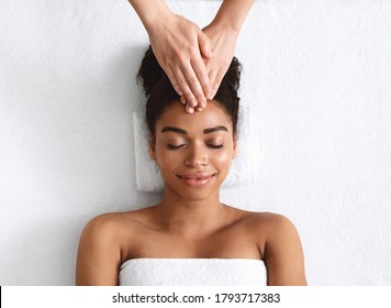 Therapist Hands Rubbing Relaxed Black Woman Forehead At Spa, Head Massage Benefits For Headache, Migraine, Stress, Top View