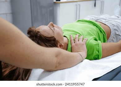 Therapist holding hands over head of young woman to transfer energy during healing reiki session - Powered by Shutterstock