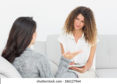 Therapist Listening To Her Talking Patient At Therapy Session