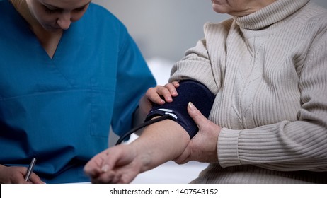 Therapist Measuring Elderly Woman Blood Pressure, Health Problems, Close Up