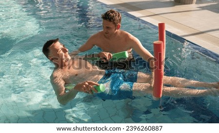 Therapist and patient using pool noodles for rehab exercises in a pool