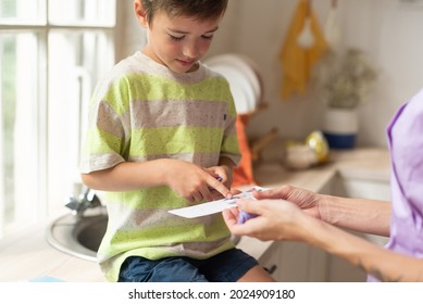 The therapist plays an educational game with the child using logic cards.