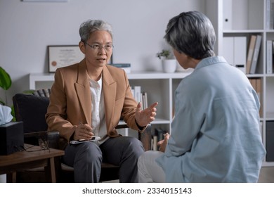 Therapist, psychologist talking and counselling to Asian patient at office during psychology treatment. - Powered by Shutterstock