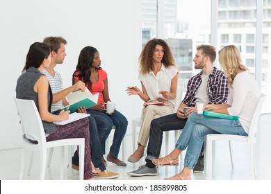 Therapist speaking to a rehab group at therapy session - Powered by Shutterstock