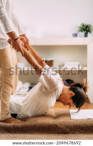 Therapist Stretching woman’s back. Shiatsu massage.