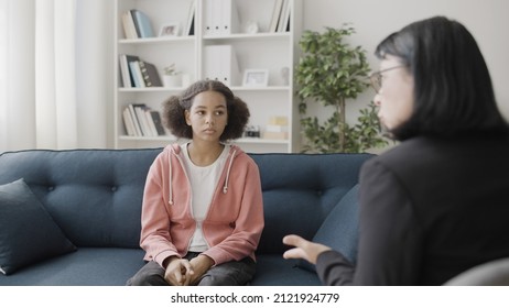 Therapist Talking To Sad Teen Girl During Counselling Session, Mental Health