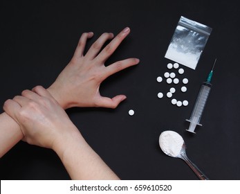 Therapist touching drug addict hand with cooked heroine, syringe and pills on black table. Stop drug addiction by rehabilitation in rehab center concept. International Day against Drug abuse.